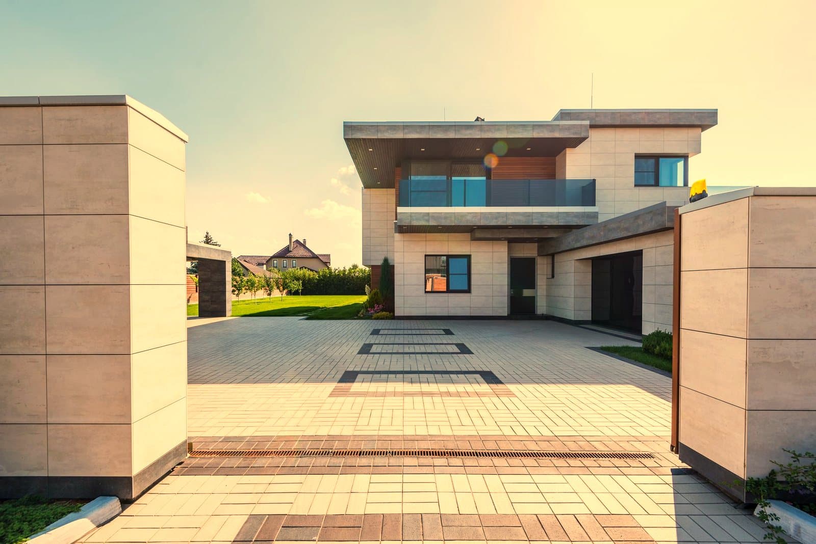 A contemporary two-storey luxury home behind a wide paved driveway
