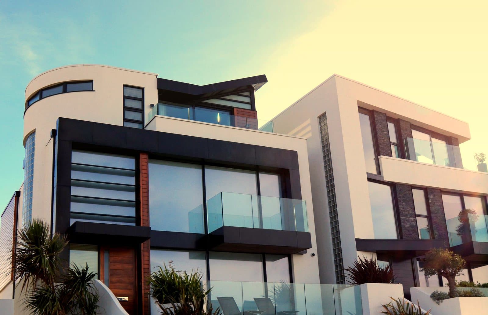 Contemporary luxury home with glass balconies in Poole, UK, showcasing modern architectural design.